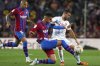 FILE - Barcelona's Ferran Torres, center, challenges Mallorca's Dani Rodriguez for the ball during a Spanish La Liga soccer match between FC Barcelona and Mallorca at the Camp Nou stadium in Barcelona, Spain, May 1, 2022. (AP Photo/Joan Monfort, File)