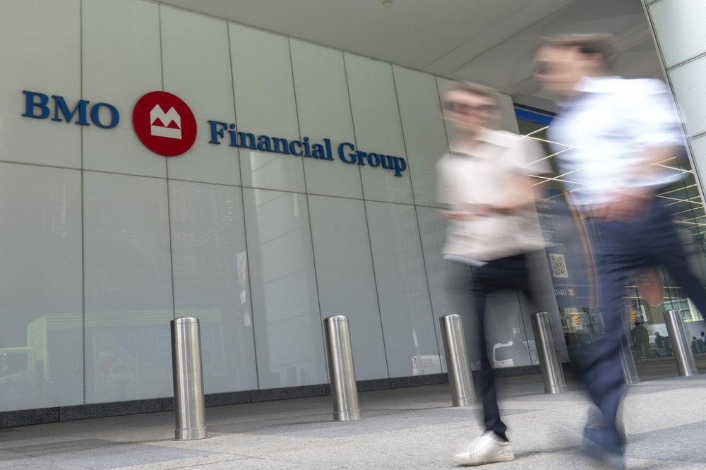 People make their way past the Bank of Montreal  building in the Financial District of Toronto, Monday, Aug. 14, 2023. THE CANADIAN PRESS/Spencer Colby