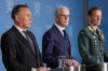 Norway's Prime Minister Jonas Gahr Store, centre, flanked by Norway's Minister of Defence Tore O. Sandvik, left, and Chief of Defence Eirik Kristoffersen, reports on the status of the purchase of frigates from the United Kingdom, at the Prime Minister's Office in Oslo, Sunday, Aug. 31, 2025. (Rodrigo Freitas/NTB Scanpix via AP)