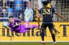 Toronto FC goalkeeper Luka Gavran (90) makes a diving save during the second half of an MLS soccer match against the Philadelphia Union, Saturday, Aug. 9, 2025, in Chester, Pa. (AP Photo/Derik Hamilton)