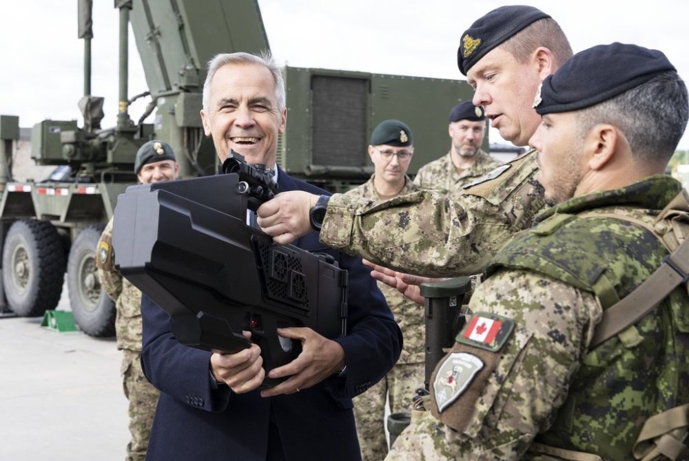 Prime Minister Mark Carney checks out an Orion-H9 Counter-UAS, a directional drone disrupter, as he visits a vehicle display at the Adazi Military base in Adazi, Latvia on Wednesday, Aug. 27, 2025. THE CANADIAN PRESS/Christinne Muschi