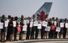 Air Canada flight attendants hold a silent protest at Montreal-Pierre Elliott Trudeau International Airport in Montreal on Monday, Aug. 11, 2025. THE CANADIAN PRESS/Christinne Muschi