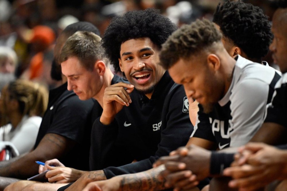 FILE - San Antonio Spurs guard Dylan Harper looks on from the bench during the first half of an NBA summer league basketball game against the Philadelphia 76ers, July 10, 2025, in Las Vegas. (AP Photo/David Becker, File)
