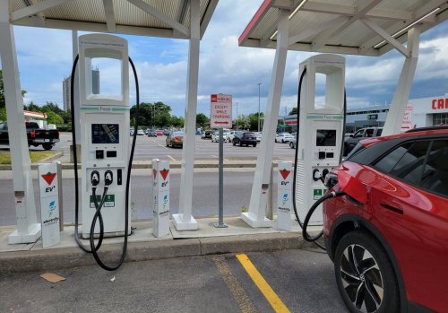 An electric vehicle is shown at a charging station at a Scarborough, Ontario Canadian Tire on Wednesday June 14, 2023. THE CANADIAN PRESS/Doug Ives