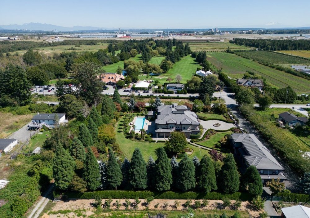 Houses along No. 6 Road and Country Meadows Golf Course, back centre, which fall within the boundaries of a Cowichan Nation Aboriginal title claim, are seen in an aerial view in Richmond, B.C., on Friday, August 22, 2025. A ruling in B.C. Supreme Court confirmed Cowichan Aboriginal title and fishing rights over a stretch of land on Lulu Island next to the south arm of the Fraser River where the nation had a summer village where members fished for salmon. According to the Cowichan Nation the village was first observed by Hudson's Bay Company officials in 1824 as containing over 108 longhouses. THE CANADIAN PRESS/Darryl Dyck