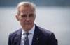 Prime Minister Mark Carney listens while touring the Royal Canadian Navy torpedo recovery vessel Sikanni at the Canadian Forces Maritime Experimental and Test Ranges (CFMETR), in Nanoose Bay, B.C., on Monday, August 4, 2025. THE CANADIAN PRESS/Darryl Dyck