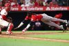 Cincinnati Reds' Elly De La Cruz, right, slides into home plate to score as Los Angeles Angels catcher Logan O'Hoppe, left, watches during the fifth inning of a baseball game, Monday, Aug. 18, 2025, in Anaheim, Calif. (AP Photo/Jessie Alcheh)