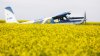 David Reid lands his 1957 Helio Courier on a landing strip bordered by his canola crop on the family's farm near Cremona, Alta., on Thursday, July 17, 2025. THE CANADIAN PRESS/Jeff McIntosh