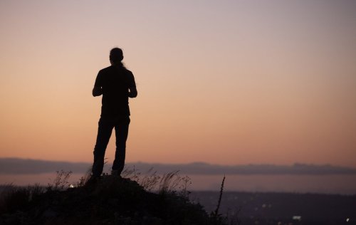 A person looks over wildfire smoke low on the horizon over Conception Bay South, N.L. on Wednesday, Aug. 13, 2025. THE CANADIAN PRESS/Paul Daly