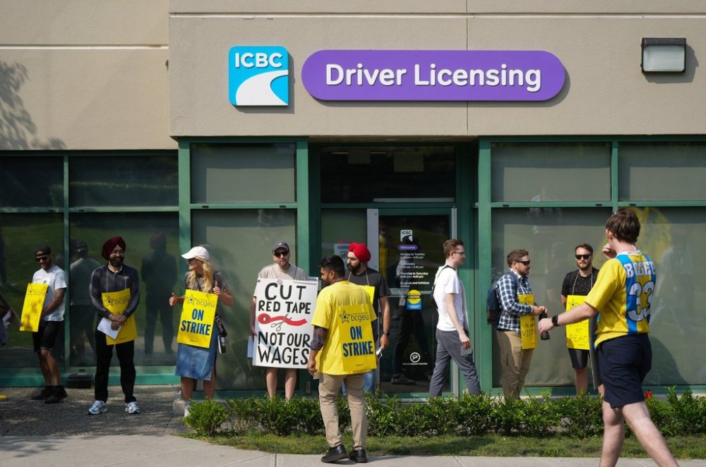 Members of the British Columbia General Employees' Union picket outside an ICBC driver licensing office, in Surrey, B.C., Tuesday, Sept. 2, 2025. THE CANADIAN PRESS/Darryl Dyck