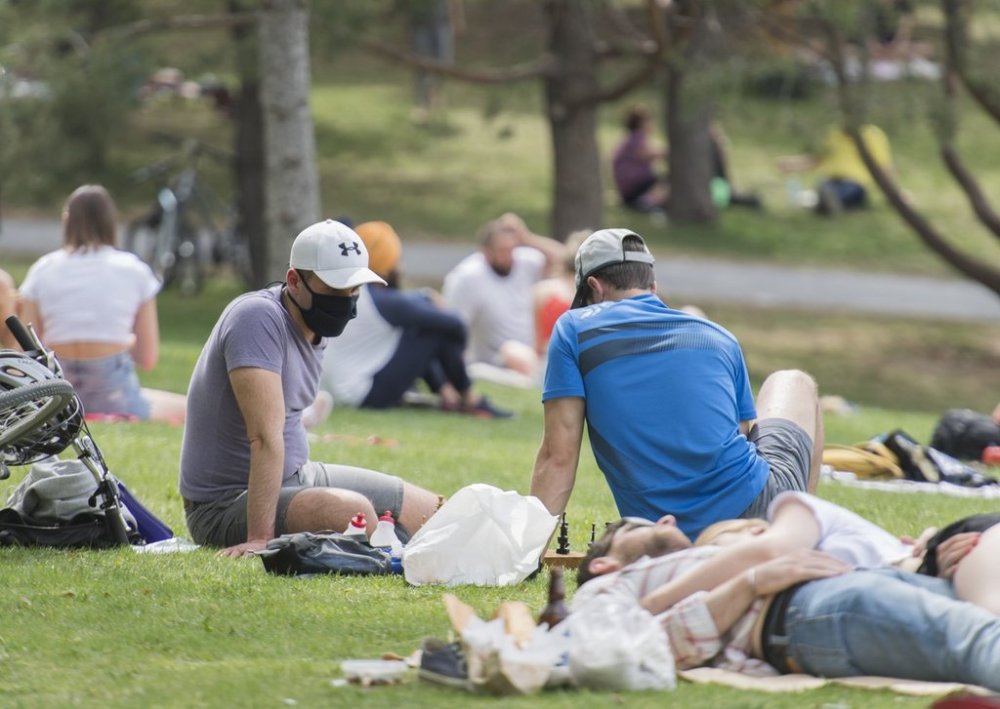 People enjoy a warm sunny day in a city park in Montreal, Sunday, May 24, 2020, during the COVID-19 pandemic. THE CANADIAN PRESS/Graham Hughes