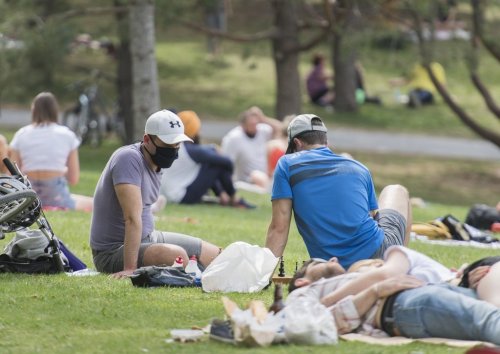 People enjoy a warm sunny day in a city park in Montreal, Sunday, May 24, 2020, during the COVID-19 pandemic. THE CANADIAN PRESS/Graham Hughes