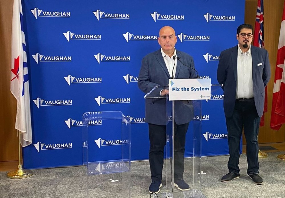 Vaughan mayor Steven Del Duca, left, speaks during a press conference as Naeem Farooqi, brother of Abdul Aleem Farooqi, looks on, in Vaughan, Ont., on Wednesday, Sept. 3, 2025. THE CANADIAN PRESS/Vanessa Tiberio