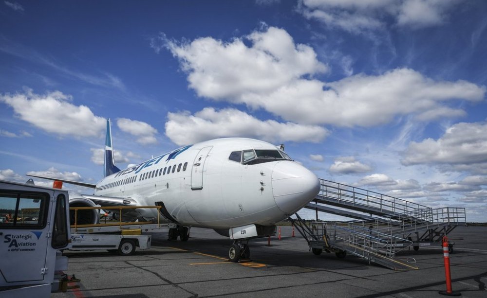 A WestJet plane on the tarmac at Yellowknife Airport on Tuesday, July 22, 2025. THE CANADIAN PRESS/Jeff McIntosh