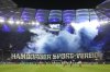 Hamburger SV fans celebrate their team with colored smoke at the start of the second half of the German Bundesliga soccer match between Hamburger SV and FC St. Pauli at Volksparkstadion in Hamburg, Germany, Friday, Aug. 29, 2025. (Christian Charisius/dpa via AP)