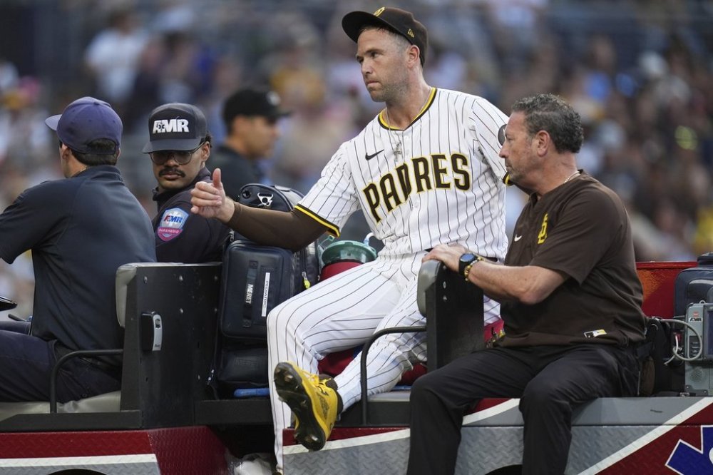San Diego Padres relief pitcher Jason Adam leaves in a cart after falling with an injury during the seventh inning of a baseball game against the Baltimore Orioles Monday, Sept. 1, 2025, in San Diego. (AP Photo/Gregory Bull)