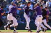 Colorado Rockies' Mickey Moniak, center, celebrates after his walkoff RBI single with Braxton Fulford (37) and Tyler Freeman, back left, and Orlando Arcia, front right, in the ninth inning of a baseball game against the Chicago Cubs, Sunday, Aug. 31, 2025, in Denver. (AP Photo/David Zalubowski)