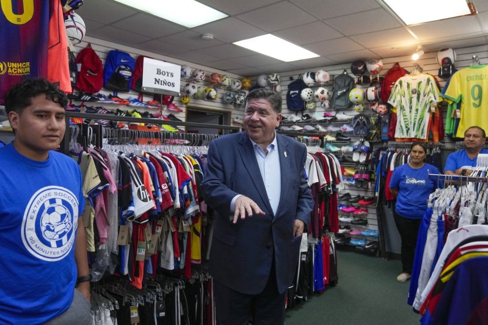 Illinois Gov. J.B. Pritzker visits with members of the family-owned soccer gear business Extreme Soccer, Thursday, Sept. 4, 2025, in Berwyn, Ill. (AP Photo/Erin Hooley)