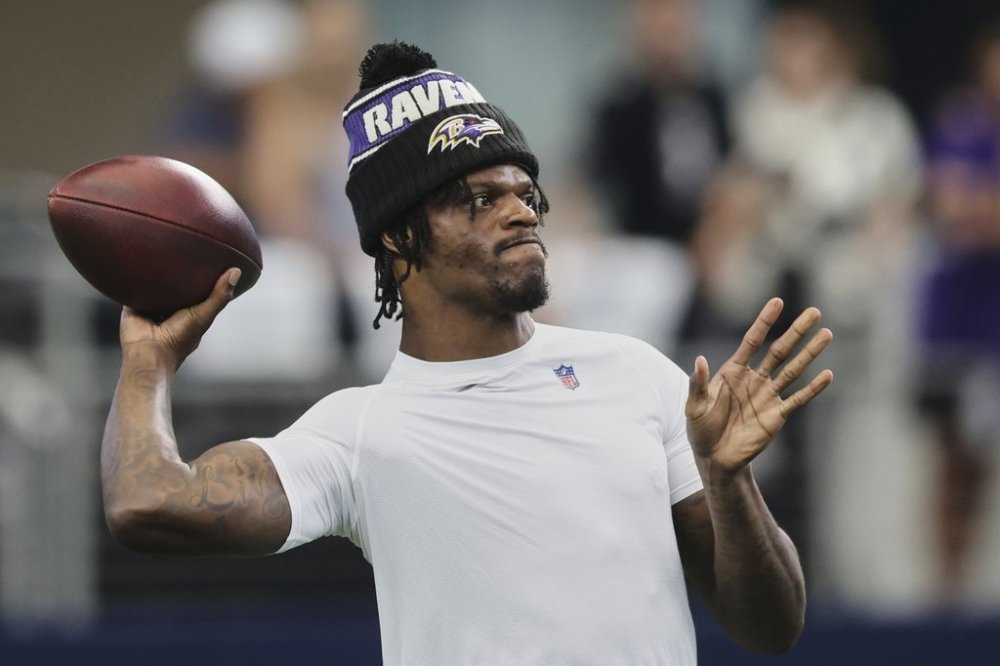 Baltimore Ravens' Lamar Jackson throws during team warmups before an NFL preseason football game against the Dallas Cowboys Saturday, Aug. 16, 2025, in Arlington, Texas. (AP Photo/Gareth Patterson)