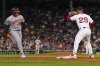 Baltimore Orioles' Samuel Basallo, left, drives home Jeremiah Jackson, breaking a 3-3 tie, as Boston Red Sox first baseman Abraham Toro (29) makes the force out in the eleventh inning of a baseball game at Fenway Park, Tuesday, Aug. 19, 2025, in Boston. (AP Photo/Charles Krupa)