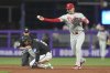 Philadelphia Phillies second baseman Bryson Stott throws to first base to complete the double play during the first inning of a baseball game against the Miami Marlins Friday, Sept. 5, 2025, in Miami. (AP Photo/Marta Lavandier)