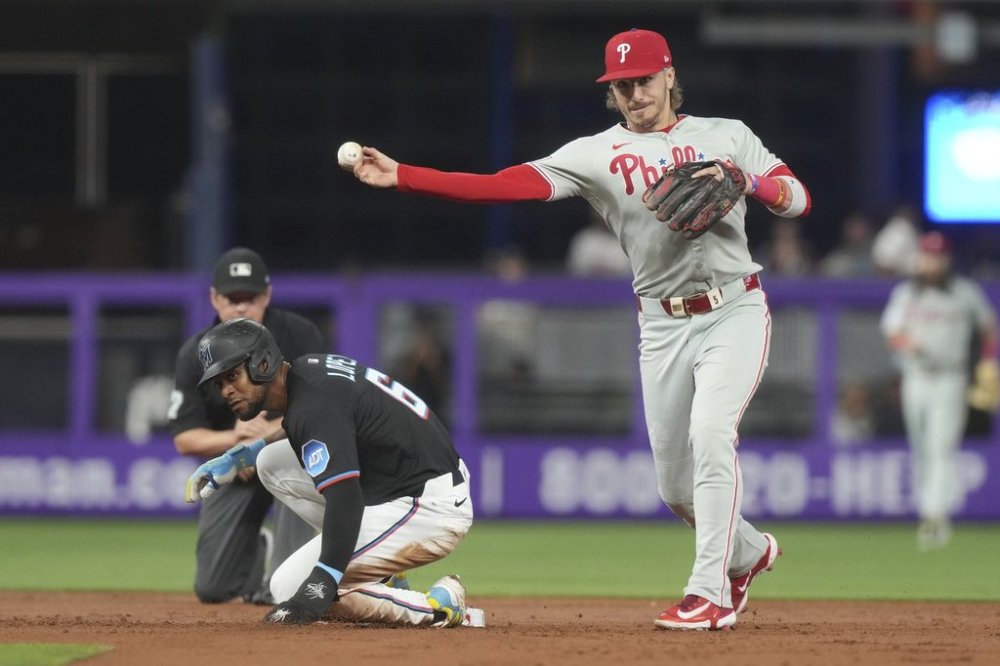 Philadelphia Phillies second baseman Bryson Stott throws to first base to complete the double play during the first inning of a baseball game against the Miami Marlins Friday, Sept. 5, 2025, in Miami. (AP Photo/Marta Lavandier)