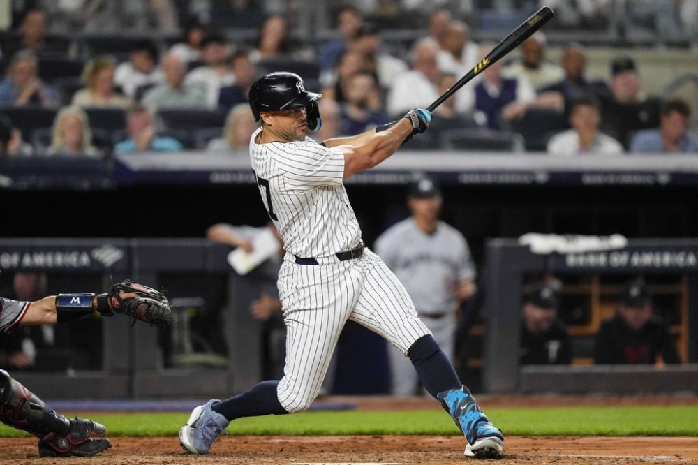 New York Yankees' Giancarlo Stanton (27) hits a home run during the fifth inning of a baseball game against the Minnesota Twins, Tuesday, Aug. 12, 2025, in New York. (AP Photo/Yuki Iwamura)
