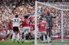 Manchester United's goalkeeper Altay Bayindir, right, tries to reach the ball before Arsenal's Riccardo Calafiori, left, scored his sides first goal during the English Premier League soccer match between Manchester United and Arsenal at Old Trafford stadium in Manchester, England, Sunday, Aug. 17, 2025. (AP Photo/Dave Thompson)