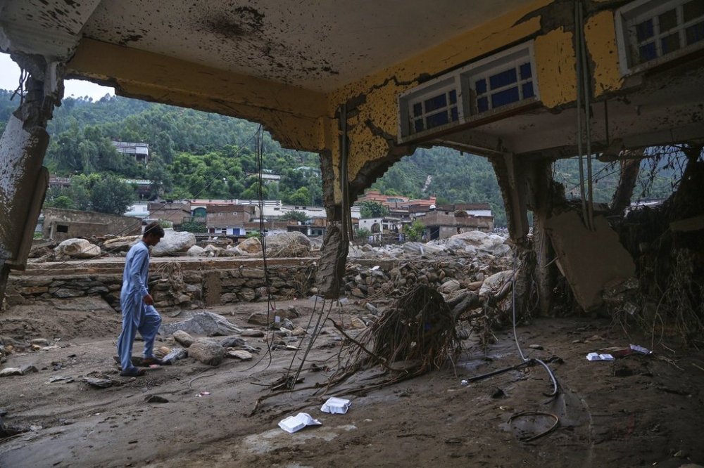 A local resident looks a damaged home following Friday's flash flooding at a neighborhood of Pir Baba, an area of Buner district, in Pakistan's northwest, Sunday, Aug. 17, 2025. (AP Photo/Muhammad Sajjad)