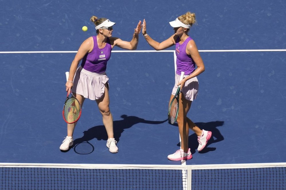 Ottawa native Gabriela Dabrowski and Montreal resident Erin Routliffe high five after a rally against American Taylor Townsend and Czechia's Katerina Siniakova during the women's doubles final of the U.S. Open tennis championships on Friday, Sept. 5, 2025, in New York. (AP Photo/Seth Wenig)