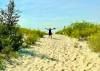 photos by Gord Mackintosh
                                Margie Mackintosh rejoices at Grand Beach’s quieter East Beach at Lake Winnipeg.
