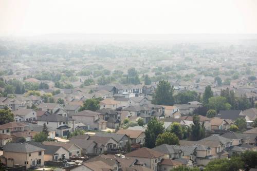 MIKAELA MACKENZIE / FREE PRESS
                                Smoke obscures neighbourhoods in the south end city on Friday.