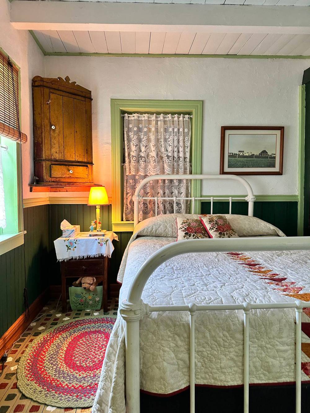 A hand-stitched quilt and tranquility await at a bedroom inside historic Herdsman’s House.