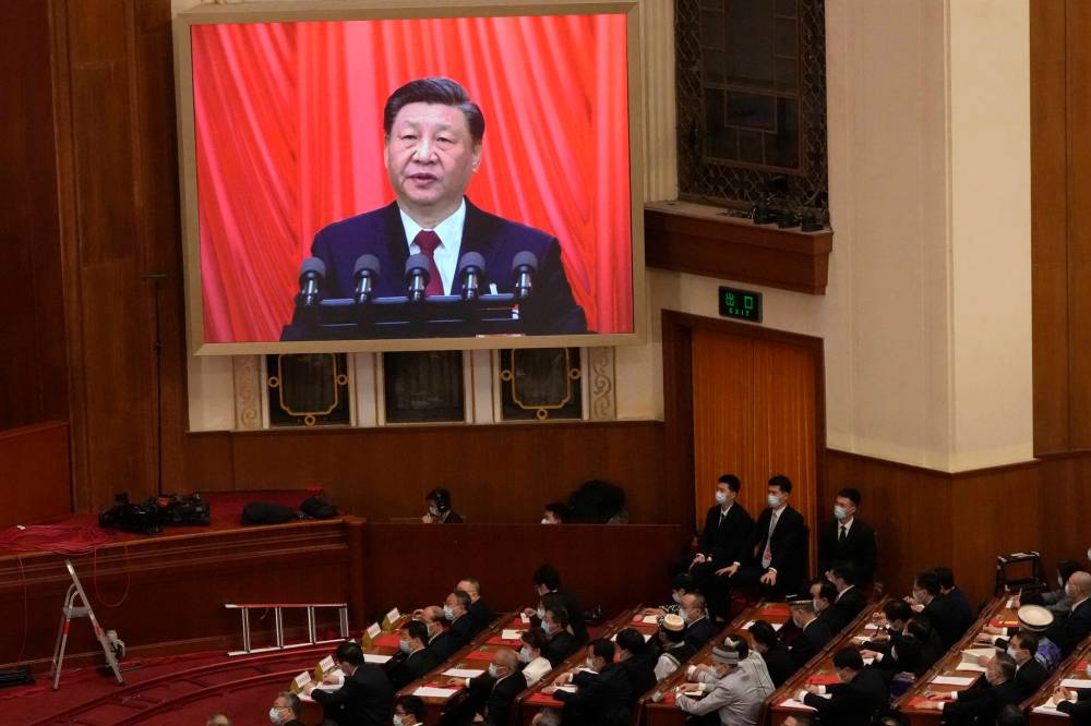 The Associated Press
China is aiming to take the lead in the battle for AI supremacy. Chinese President Xi Jinping is displayed on a screen as he delivers a speech at the closing ceremony for China’s National People’s Congress at the Great Hall of the People in Beijing on March 13.
