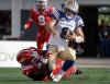 Winnipeg Blue Bombers quarterback Zach Collaros, right, is sacked by Calgary Stampeders’ Jaylon Hutchings during second half CFL football action in Calgary, Alta., Saturday, Aug. 9, 2025. THE CANADIAN PRESS/Jeff McIntosh
