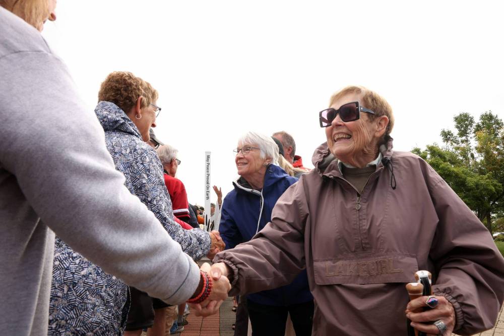 Canadians and Americans greet each other at the Manitoba / North Dakota border as a symbol of peace and friendship Saturday. (Tim Smith/The Brandon Sun)