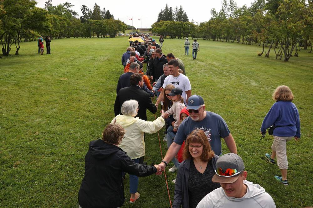 Americans and Canadians line up along the border of Manitoba and North Dakota at the Peace Garden in a display of neighbourly co-operation. (Tim Smith/The Brandon Sun)