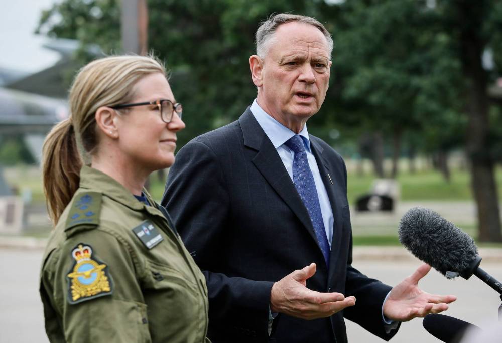 JOHN WOODS / FREE PRESS
Lieutenant-General Jamie Speiser-Blanchet, commander and chief of the Royal Canadian Air Force (RCAF), and David McGuinty, minister of national defence, speak to media outside Canadian Forces Base 17 Wing Winnipeg Tuesday.
