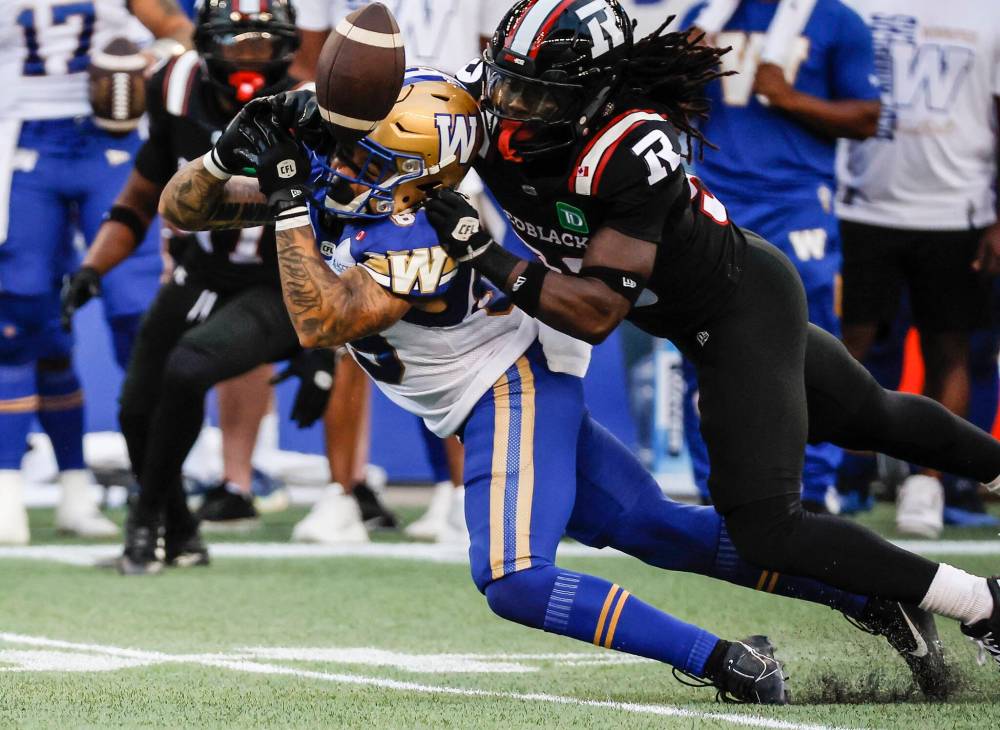 John Woods / THE CANADIAN PRESS
Ottawa Redblacks’ Deandre Lamont defends against Winnipeg Blue Bombers’ Jerreth Sterns in the first half.