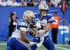 John Woods / THE CANADIAN PRESS
                                Winnipeg Blue Bombers quarterback Zach Collaros (right) hands off to Brady Oliveira on Thursday. Collaros put up solid numbers on the night, completing 24-for-34 attempts for 298 yards and a touchdown on the night despite his two turnovers.
