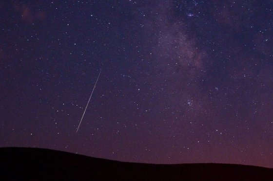 A Perseid meteor streaks across the sky during the Perseid meteor shower in Vinton, Calif., in 2009. (Kevin Clifford / The Associated Press files)