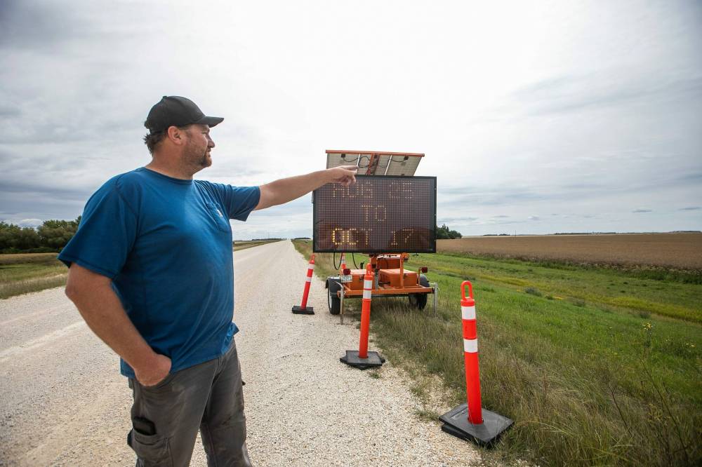 MIKAELA MACKENZIE / FREE PRESS
Macdonald-area farmer Dustin Wiens by the closure of Floodway Road on Monday. Construction that could have waited until spring will impact harvest for many in the area, he says.