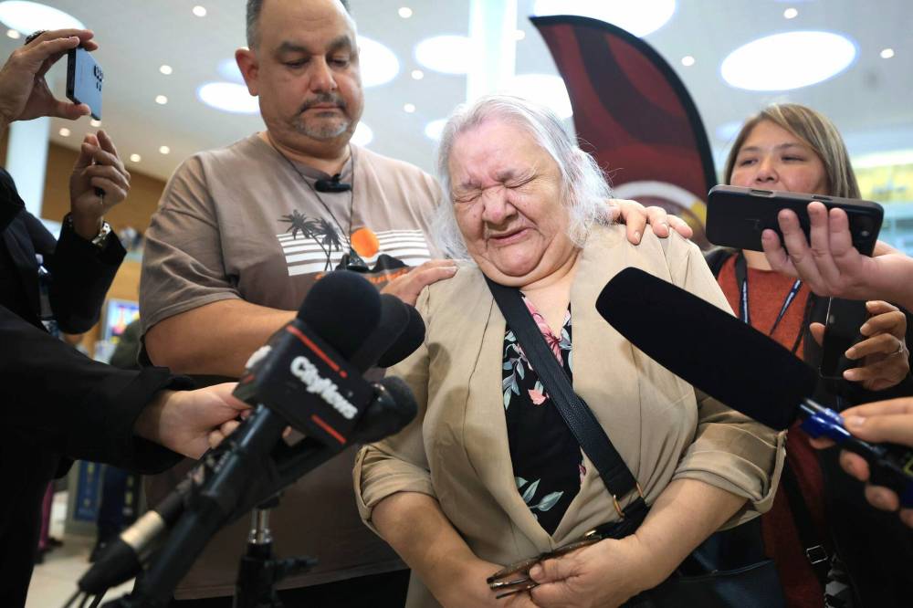 RUTH BONNEVILLE / FREE PRESS
Patsy George cries while speaking to the media after meeting her son for the first time since 1975.