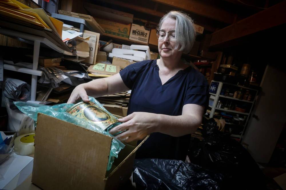 JOHN WOODS / FREE PRESS
Lisa Boland, owner of Bitchin’ Kitsch ’n’ Kitchen, packs an item at her shipping table in her home in Winnipeg. She’s expecting a drop in sales as the de minimis exemption to tariffs is halted.