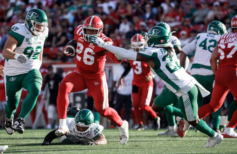 JEFF MCINTOSH / THE CANADIAN PRESS
                                Calgary Stampeders running back Dedrick Mills evades a tackle during the Stamps 32-15 win over the Saskatchewan Roughriders on Saturday. The Stampeders swept both season series against the Roughriders and Winnipeg Blue Bombers.