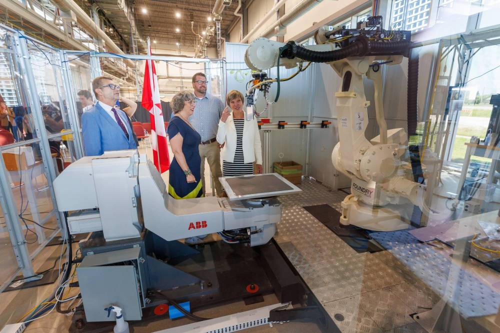 MIKE DEAL / FREE PRESS
                                Liberal MP Doug Eyolfson (from left), Liberal MP Ginette Lavack, PhiBer Manufacturing owner Derek Friesen and Eleanor Olszewski (minister responsible for Prairies Economic Development Canada) look at one of the robotic arms at the National Research Council research facility after a funding announcement in Winnipeg on Thursday.