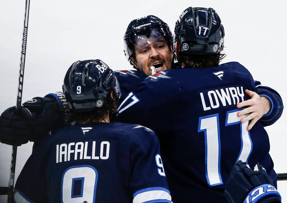 JOHN WOODS / THE CANADIAN PRESS FILES
Winnipeg Jets’ Mark Scheifele (centre) said ‘it was pretty special to play in that game,’ as the centre had received support from his family, friends ‘and even people from around the league.’