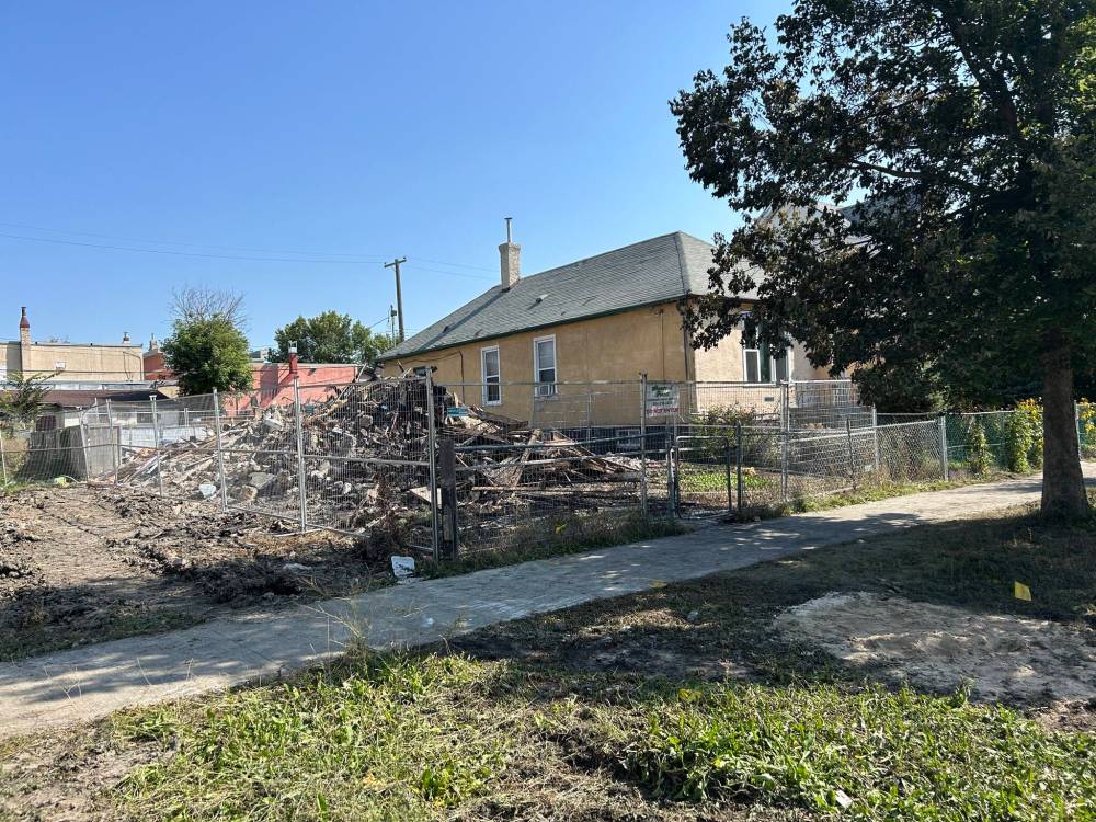 JOHN WOODS / FREE PRESS
                                Sunday morning, all that remained of Jonathan Roger Hein’s Pritchard Avenue home was a pile of charred rubble behind a perimeter of metal security fencing.