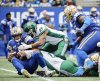 Winnipeg Blue Bombers quarterback Zach Collaros (8) gets sacked by Saskatchewan Roughriders' Malik Carney (11) and Shane Ray (5) during first half CFL action in Winnipeg, Saturday, Sept. 6, 2025. THE CANADIAN PRESS/John Woods