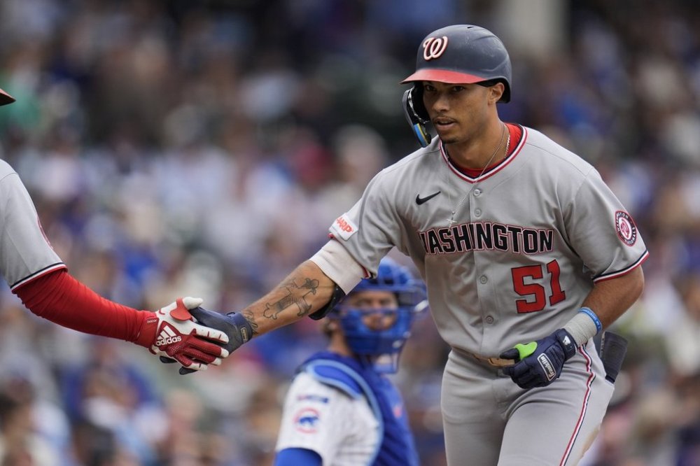 Washington Nationals' Daylen Lile (51) celebrates after hitting a home run during the fourth inning of a baseball game against the Chicago Cubs, Saturday, Sept. 6, 2025, in Chicago. (AP Photo/Erin Hooley)